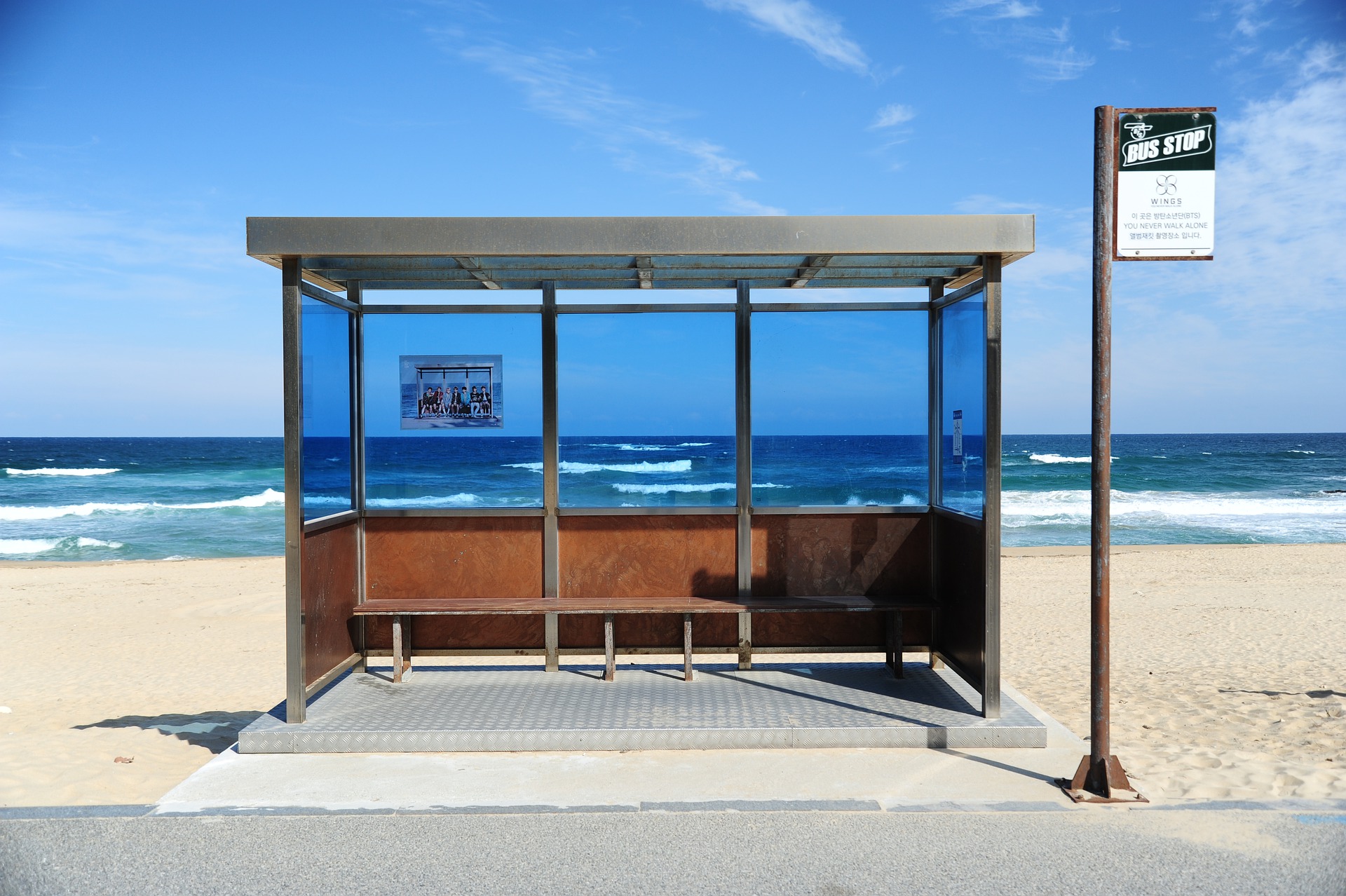 A picture of a bus stop on a beach